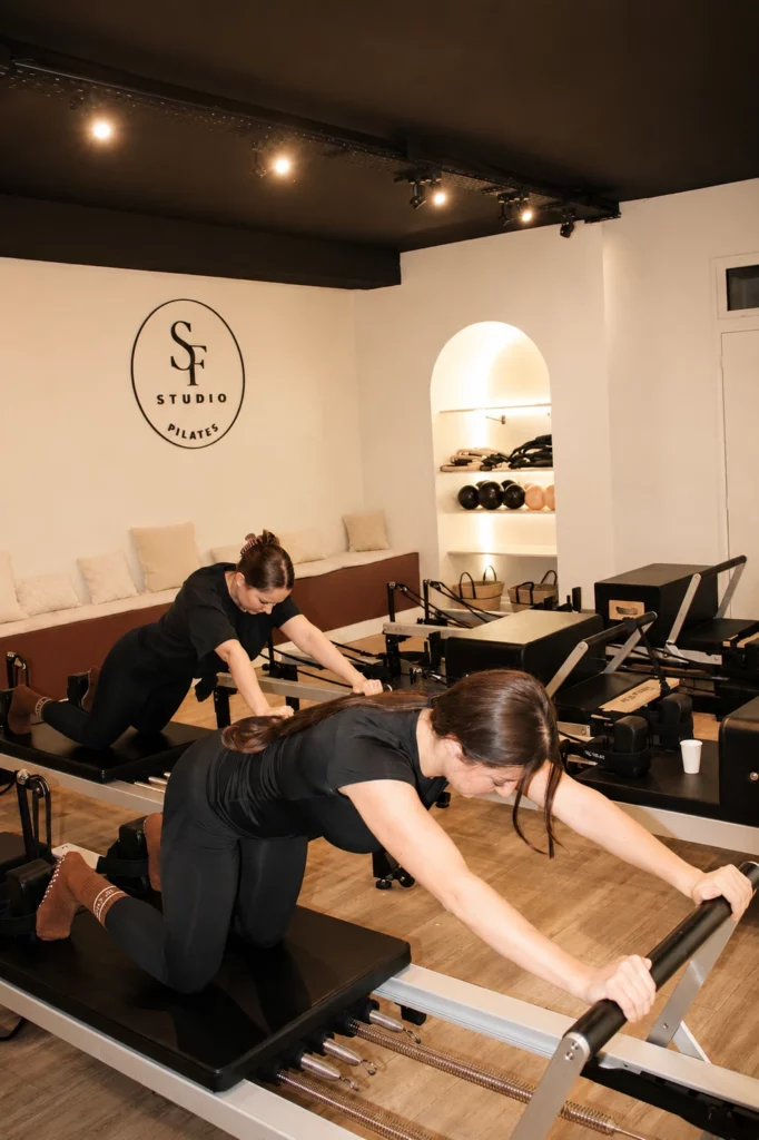 Deux femmes pratiquant des exercices sur machine Pilates Reformer à Romainville.